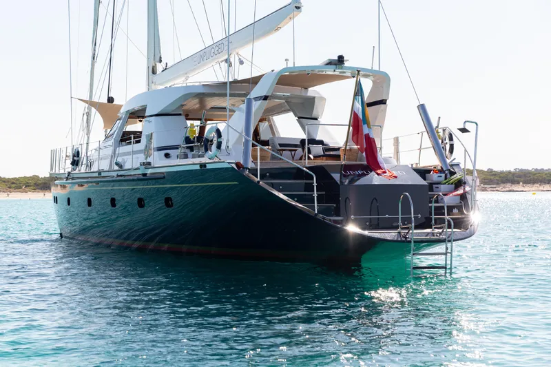 Unplugged Yacht Photos Pics Luxurious 1993 Valdettaro 112 yacht anchored in clear blue waters.