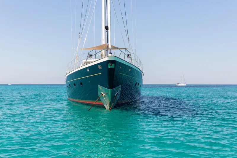 Unplugged Yacht Photos Pics Valdettaro 112 yacht from 1993 anchored in clear turquoise waters.