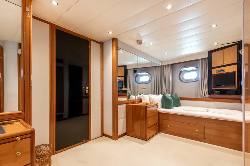 Unplugged Yacht Photos Pics Luxurious Valdettaro 112 yacht bedroom interior, featuring elegant wood finishes and modern amenities.