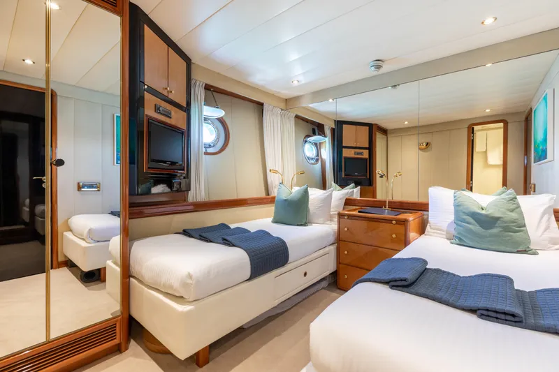 Unplugged Yacht Photos Pics Luxurious Valdettaro 112 yacht cabin, 1993 model, featuring twin beds and elegant decor.