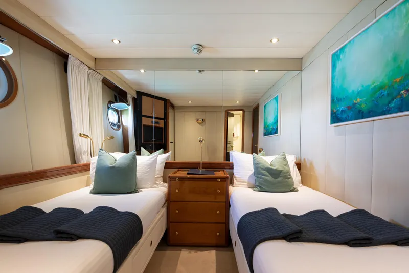 Unplugged Yacht Photos Pics Luxurious twin cabin interior of 1993 Valdettaro 112 yacht with elegant decor and artwork.