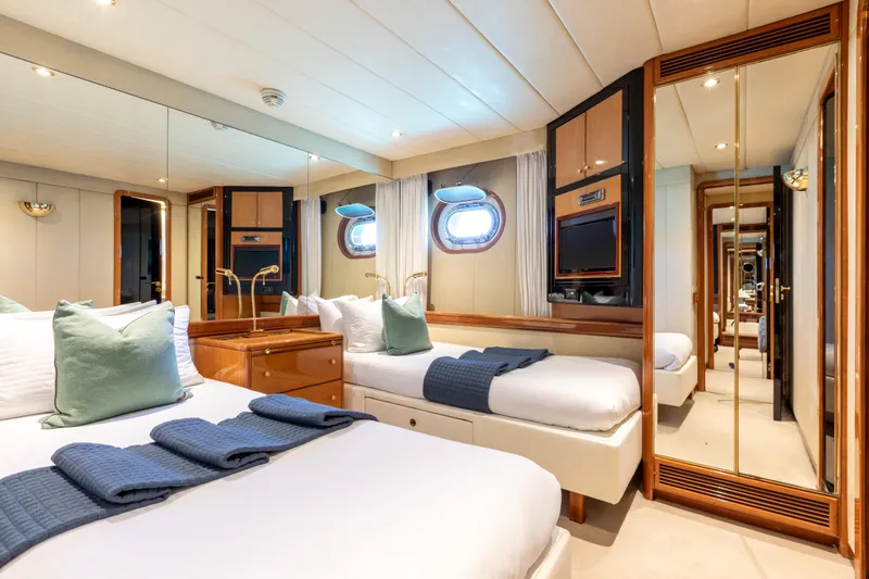 Unplugged Yacht Photos Pics Luxurious Valdettaro 112 yacht bedroom interior, featuring elegant decor and comfortable twin beds.
