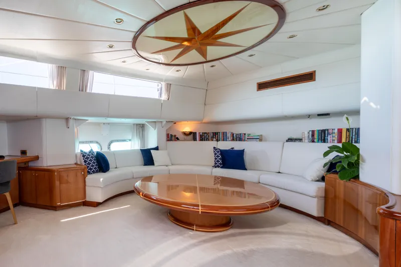 Unplugged Yacht Photos Pics Luxurious Valdettaro 112 yacht interior, featuring elegant seating and a stylish wooden table, 1993 model.