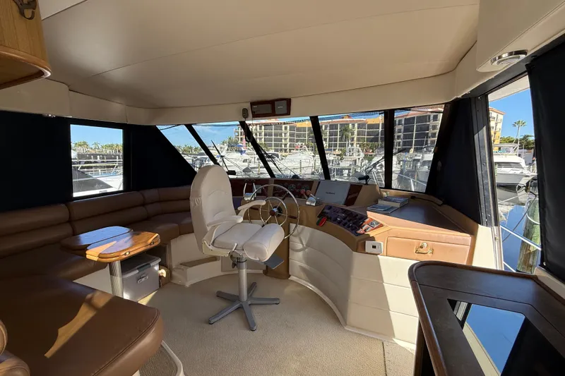  Yacht Photos Pics Interior of 2002 Bayliner 4788 Pilot House Motoryacht with helm and seating area.