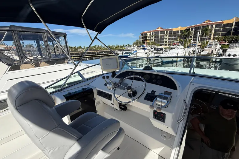  Yacht Photos Pics 2002 Bayliner 4788 Pilot House Motoryacht helm with steering wheel and navigation equipment.