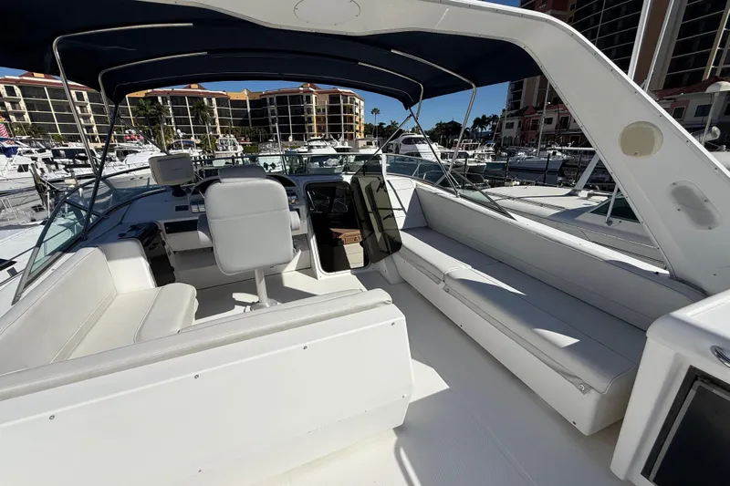  Yacht Photos Pics 2002 Bayliner 4788 Pilot House Motoryacht interior with seating and helm, docked at marina.