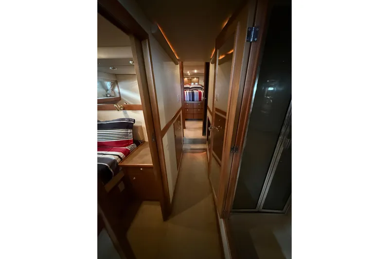  Yacht Photos Pics Interior hallway of 2002 Bayliner 4788 Pilot House Motoryacht, featuring cozy cabins.