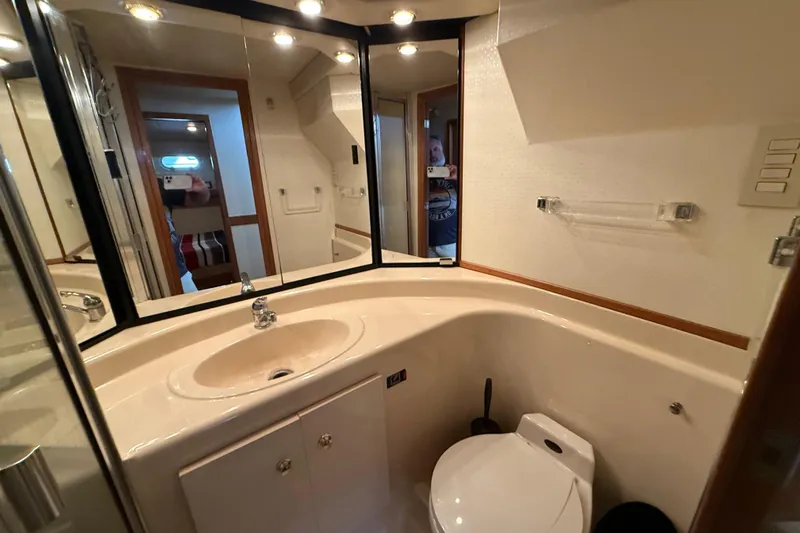  Yacht Photos Pics Luxurious bathroom in 2002 Bayliner 4788 Pilot House Motoryacht with modern fixtures and ample lighting.