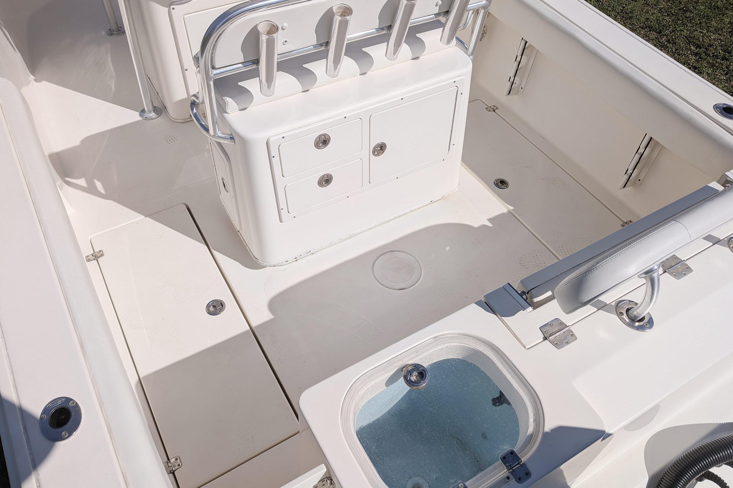 2019 Cobia 237 Center Console boat interior with storage compartments and rod holders.