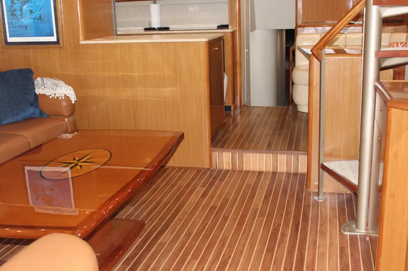 Killin Time Yacht Photos Pics Interior of 2003 Viking 65 Convertible Enclosed Bridge with wooden flooring and modern furnishings.