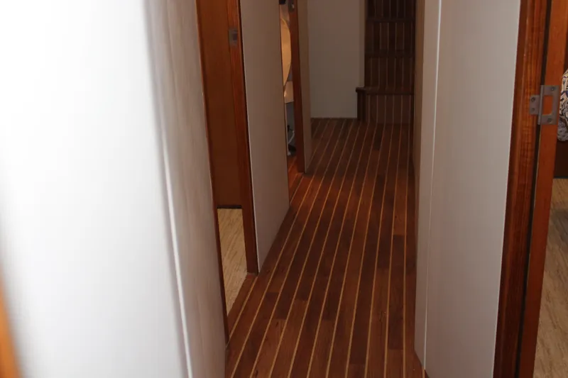Killin Time Yacht Photos Pics Hallway with wooden flooring on a 2003 Viking 65 Convertible Enclosed Bridge yacht.