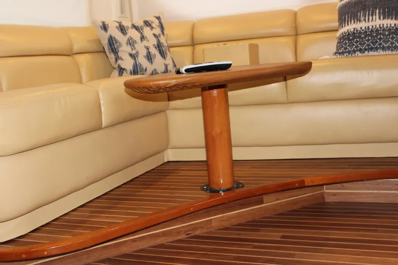 Killin Time Yacht Photos Pics Luxurious interior of 2003 Viking 65 Convertible yacht with leather seating and wooden table.