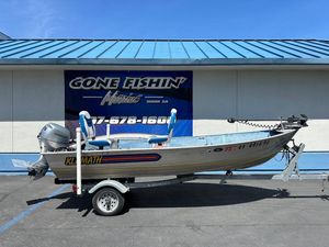 1998 Klamath 14 DLX boat on trailer, parked outside 