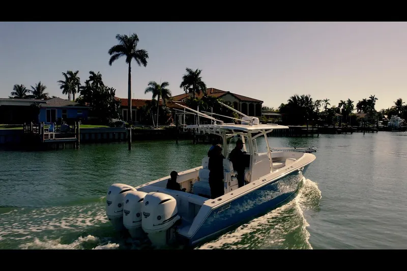  Yacht Photos Pics 2013 Jupiter 34 FS boat cruising on a scenic waterway with palm trees.
