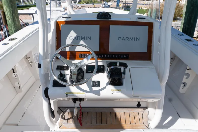  Yacht Photos Pics 2013 Jupiter 34 FS boat helm with dual Garmin displays and steering wheel.