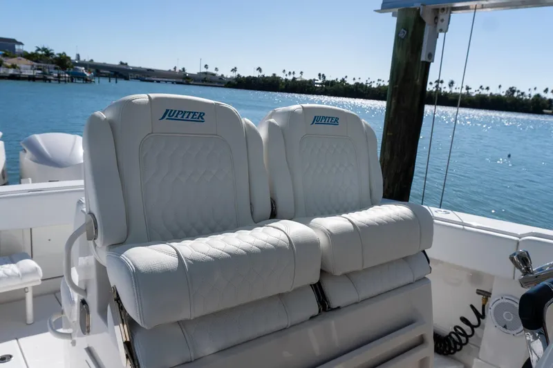  Yacht Photos Pics Luxury seating on 2013 Jupiter 34 FS boat, overlooking serene waterfront.