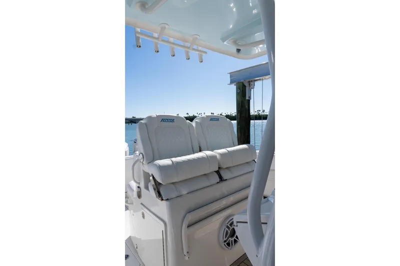 Yacht Photos Pics Luxury seating on 2013 Jupiter 34 FS boat, featuring plush white cushions and ocean backdrop.