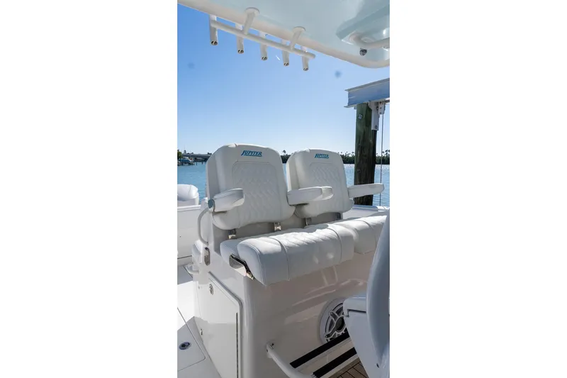  Yacht Photos Pics 2013 Jupiter 34 FS boat seats with armrests, docked by the water.