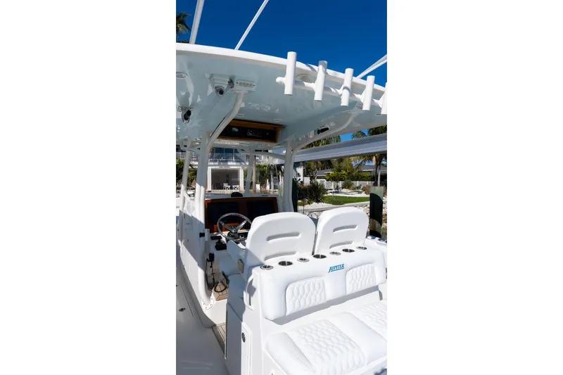  Yacht Photos Pics 2013 Jupiter 34 FS boat interior with helm and seating under clear blue sky.
