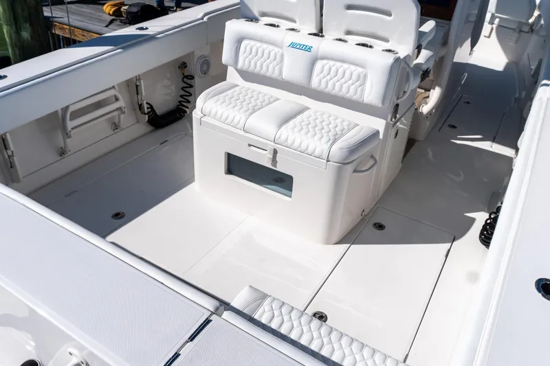  Yacht Photos Pics 2013 Jupiter 34 FS boat interior with white seating and storage compartments.