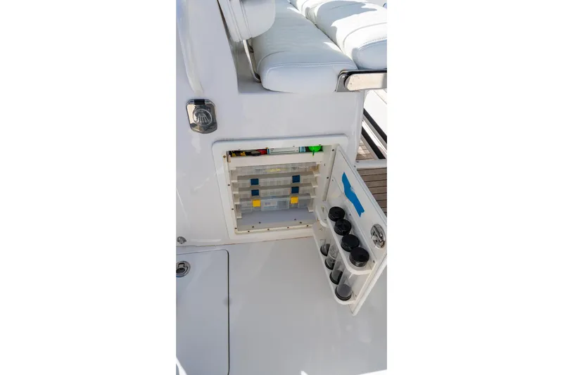  Yacht Photos Pics 2013 Jupiter 34 FS boat storage compartment with tackle boxes and cup holders.