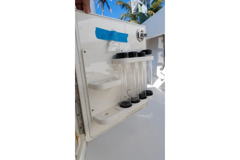  Yacht Photos Pics 2013 Jupiter 34 FS boat storage compartment with test tubes and blue tape.