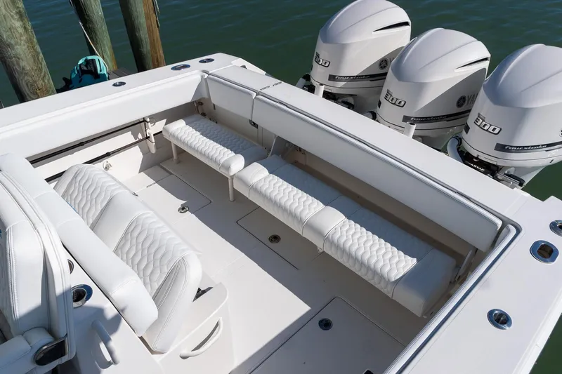  Yacht Photos Pics 2013 Jupiter 34 FS boat interior with white seating and triple outboard engines.