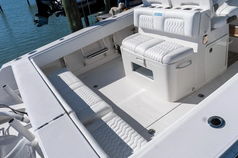  Yacht Photos Pics 2013 Jupiter 34 FS boat interior with white cushioned seating and storage.