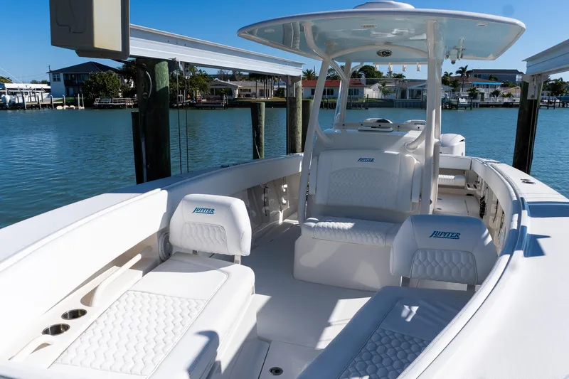  Yacht Photos Pics 2013 Jupiter 34 FS boat interior with white seating, docked by calm waters.