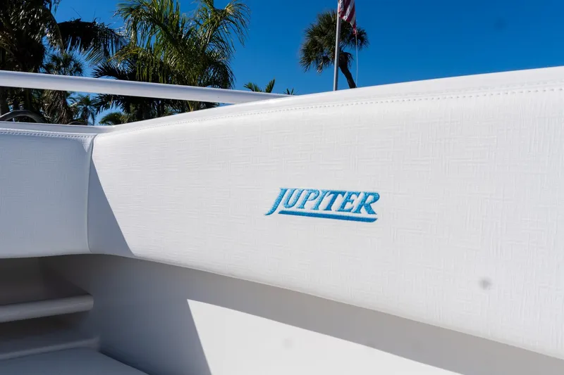  Yacht Photos Pics 2013 Jupiter 34 FS boat interior with logo, surrounded by palm trees and clear blue sky.