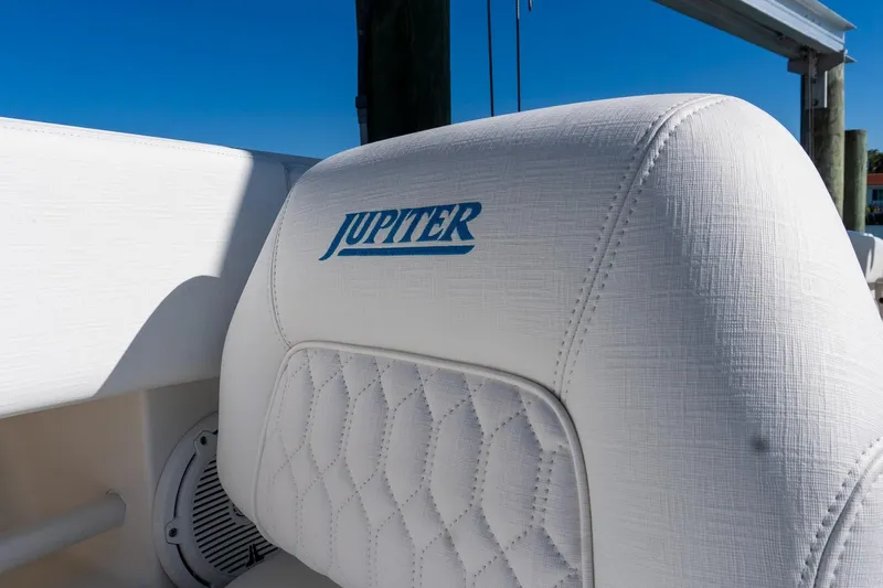  Yacht Photos Pics 2013 Jupiter 34 FS boat seat with logo, featuring white quilted upholstery.