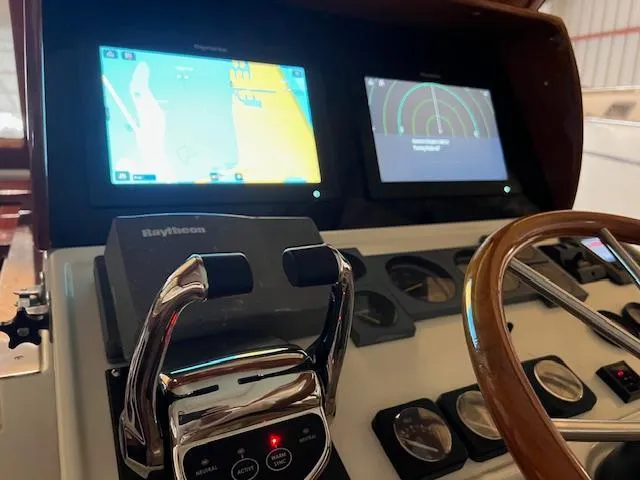 Daisy IV Yacht Photos Pics Control panel of 2001 Little Harbor WhisperJet 44 with navigation screens and steering wheel.