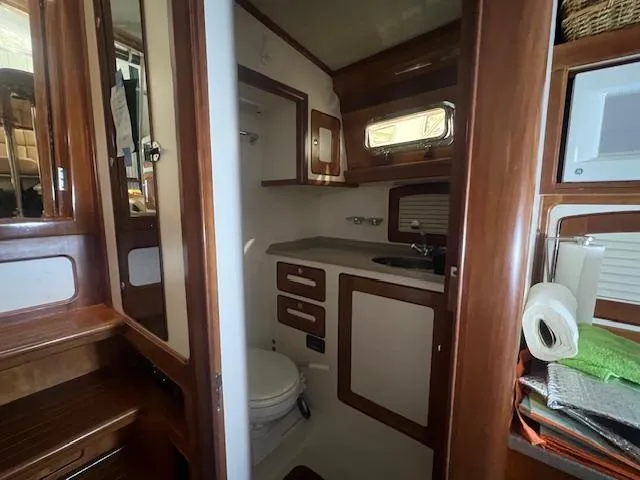 Daisy IV Yacht Photos Pics Interior of 2001 Little Harbor WhisperJet 44 yacht bathroom with wooden cabinetry.
