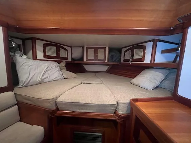 Daisy IV Yacht Photos Pics Cozy cabin interior of 2001 Little Harbor WhisperJet 44 with cushioned bed and wooden accents.