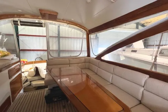 Daisy IV Yacht Photos Pics Interior of 2001 Little Harbor WhisperJet 44 yacht with elegant seating and wooden table.