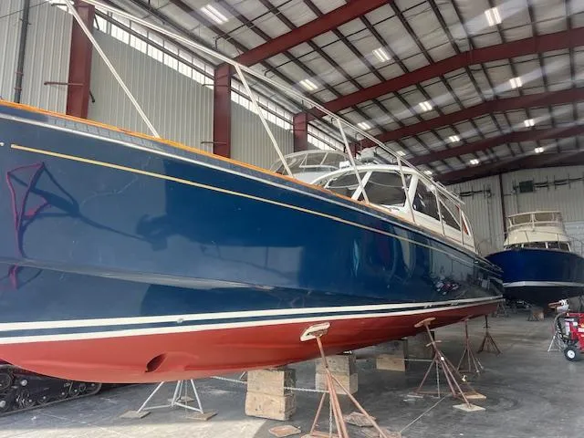 Daisy IV Yacht Photos Pics 2001 Little Harbor WhisperJet 44 boat in storage, blue hull, red bottom, indoor facility.