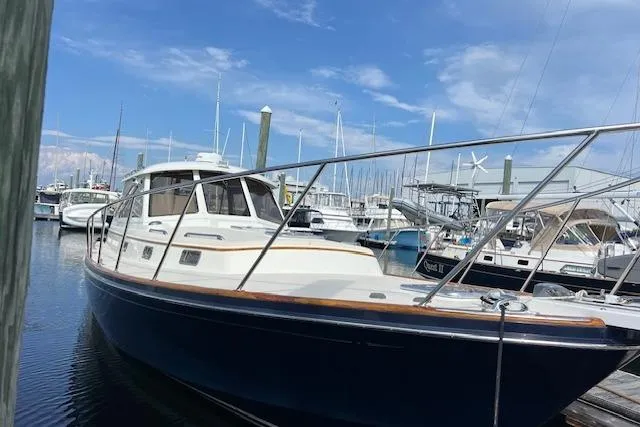 Daisy IV Yacht Photos Pics 2001 Little Harbor WhisperJet 44 docked in a marina under a clear blue sky.