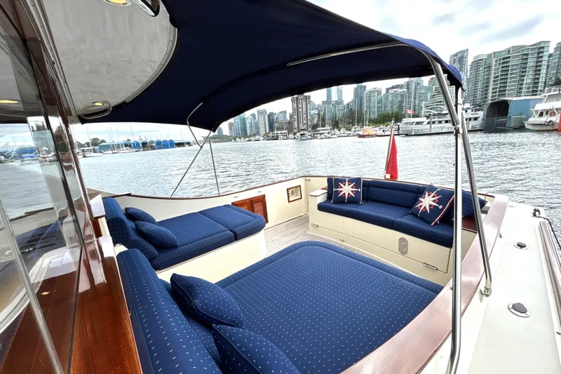 Flight Yacht Photos Pics Luxurious 2009 San Juan 48 yacht with blue seating, city skyline in background.