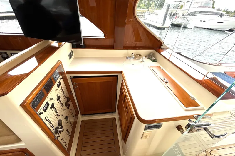 Flight Yacht Photos Pics Luxurious 2009 San Juan 48 yacht interior with wooden cabinetry and control panel.