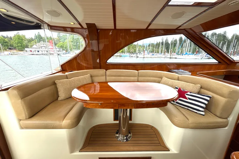 Flight Yacht Photos Pics Luxurious interior of 2009 San Juan 48 yacht with elegant seating and polished wood table.