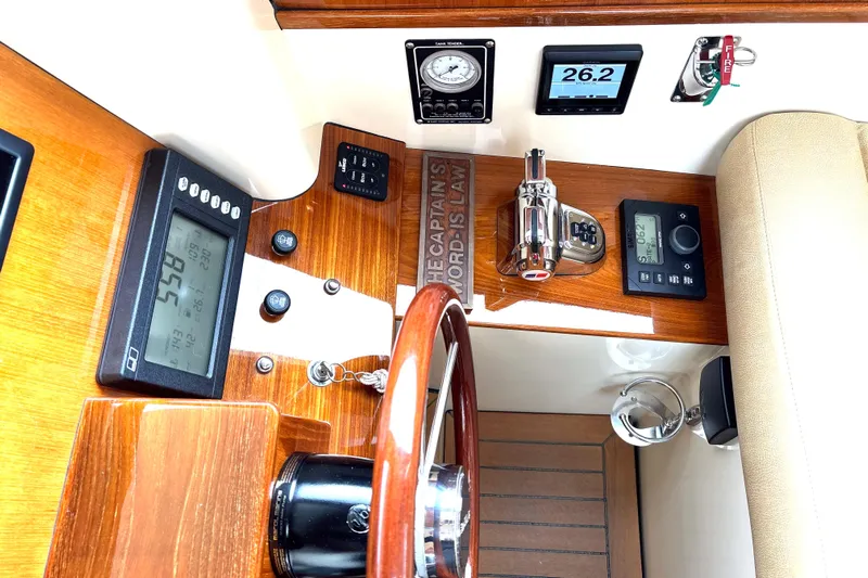 Flight Yacht Photos Pics 2009 San Juan 48 yacht dashboard with navigation instruments and wooden steering wheel.
