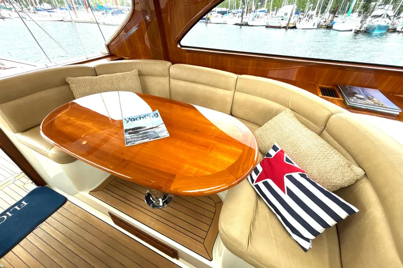 Flight Yacht Photos Pics Luxurious 2009 San Juan 48 yacht interior with elegant wood table and comfortable seating.