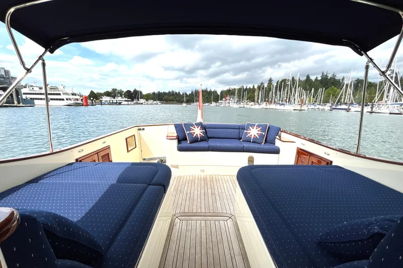 Flight Yacht Photos Pics Luxurious 2009 San Juan 48 yacht with elegant seating, docked in a scenic marina.