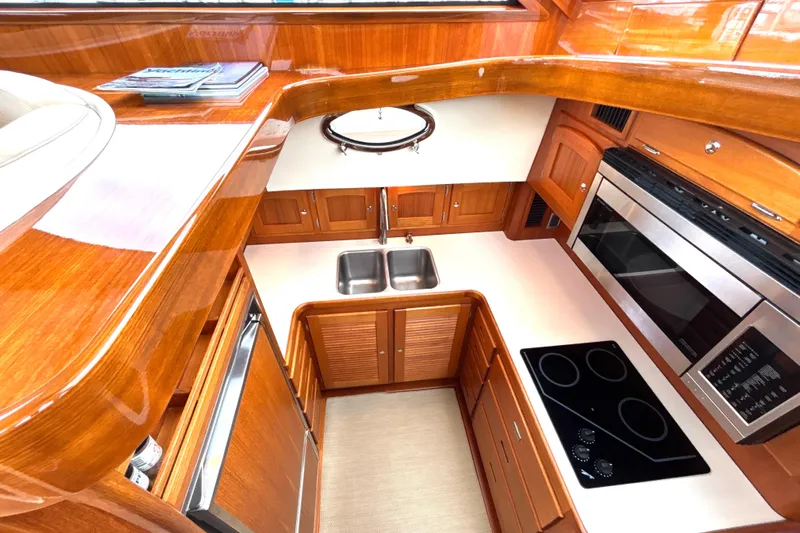 Flight Yacht Photos Pics Luxurious 2009 San Juan 48 yacht kitchen with wood cabinetry and modern appliances.