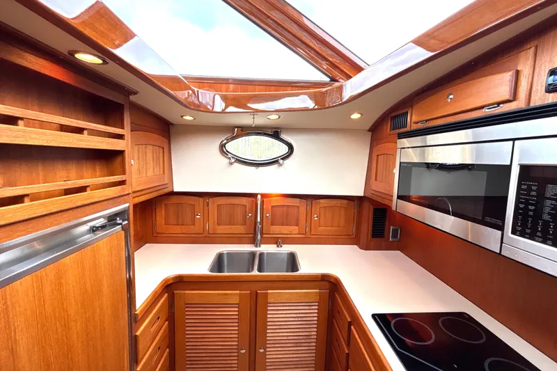 Flight Yacht Photos Pics Luxurious 2009 San Juan 48 yacht kitchen with wood cabinetry and modern appliances.