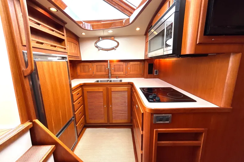 Flight Yacht Photos Pics Luxurious 2009 San Juan 48 yacht kitchen with wood cabinetry and modern appliances.