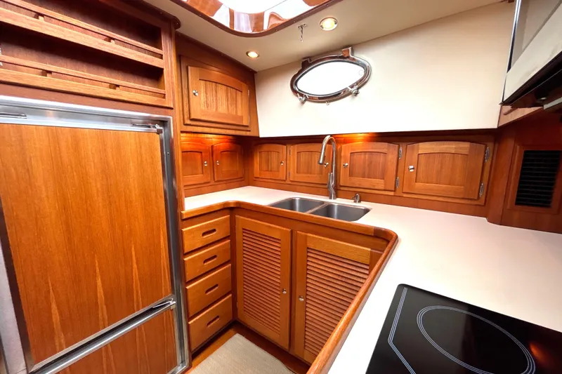 Flight Yacht Photos Pics Luxurious wooden kitchen interior of 2009 San Juan 48 yacht with modern amenities.