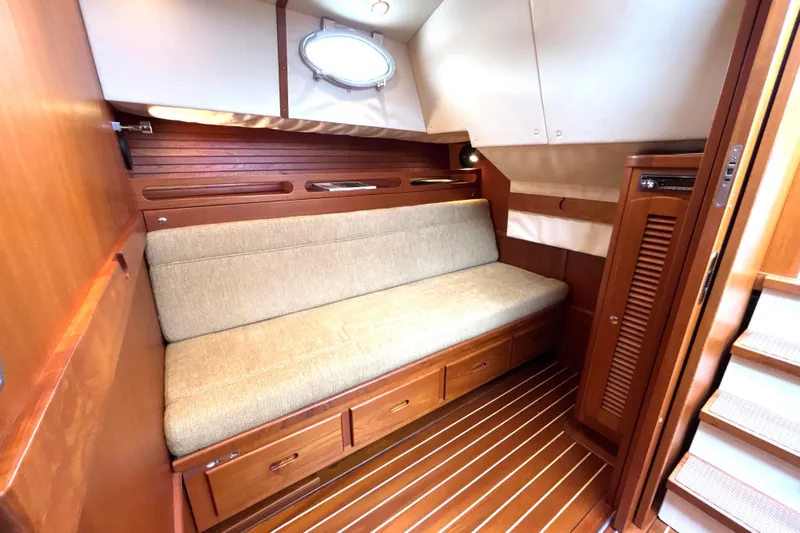 Flight Yacht Photos Pics Luxurious 2009 San Juan 48 yacht interior with wooden finishes and cozy seating area.