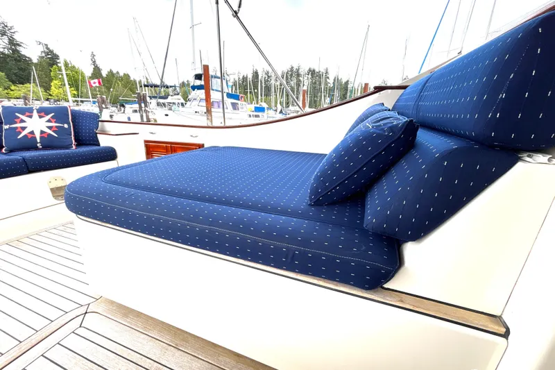 Flight Yacht Photos Pics Luxurious seating on 2009 San Juan 48 yacht with blue cushions in marina setting.