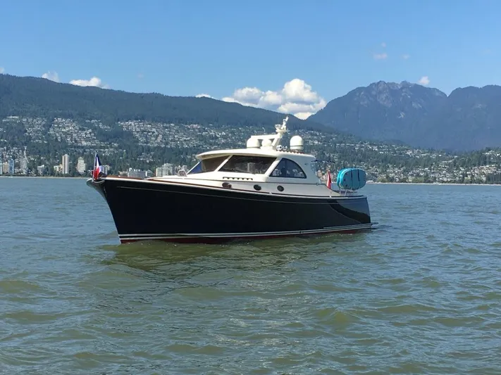 Flight Yacht Photos Pics San Juan 48 yacht from 2009 on a scenic lake with mountains in the background.